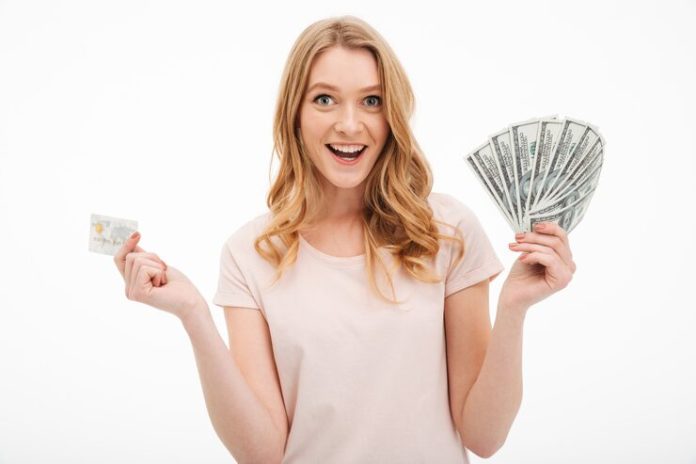 smiling-young-lady-holding-money-credit-card_171337-1566